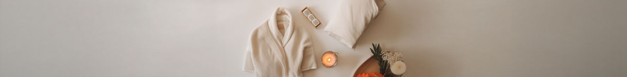 Spa-style bathroom setup with robe candle and flowers for a calming shower routine