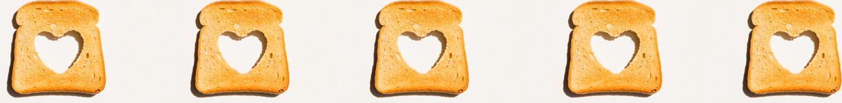 Slices of toast with heart-shaped cutouts, representing small acts of love and simple self-care moments