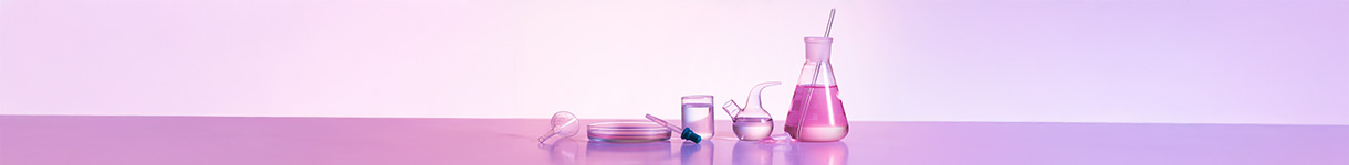 Minimalist arrangement of transparent beakers and flasks with pink vegan-friendly skincare liquids