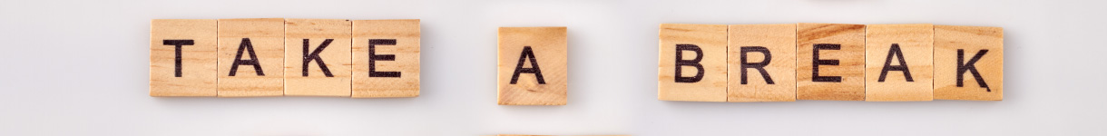 Wooden letter tiles spelling âTake a Break,â encouraging quick self-care pauses during the day.