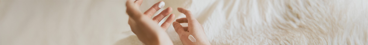 Hands gently applying cream on the skin, illustrating nourishing bodycare rituals