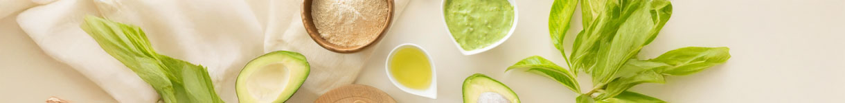 Close-up of hands offering a green gift box, representing ethical gifting and vegan beauty choices