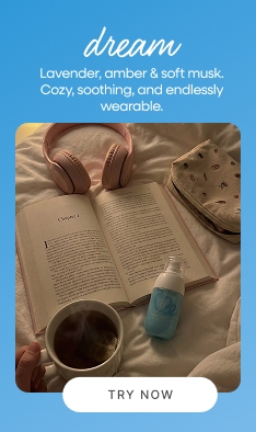 POV style flat lay of book tea cup and Dear Me Dream hand cream on bed representing cozy nighttime self care ritual