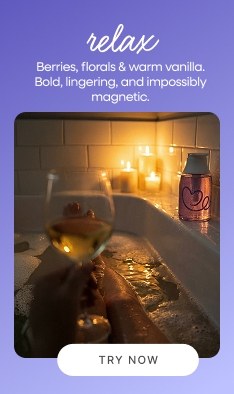 POV candlelit bath with Dear Me Relax body wash and white wine glass representing a luxurious personal self care moment